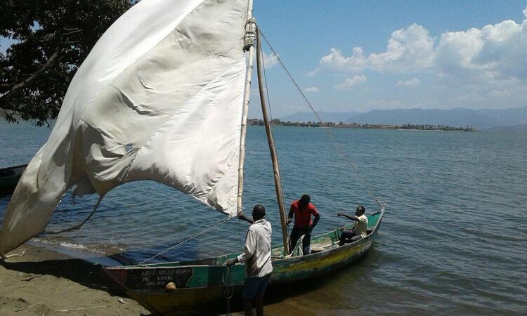 Fishermen docking on land from the lake. Fishermen docking on land from the lake.